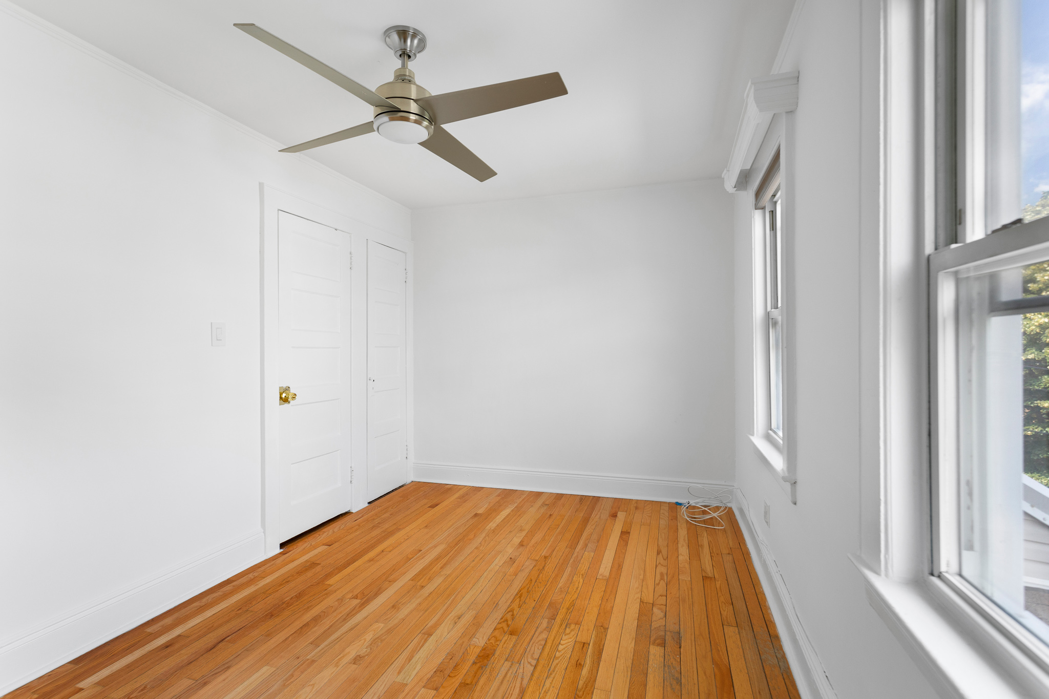 91-22 92nd Street Queens, NY 11421 - Photo 9 of 27 a view of a room with wooden floor and a ceiling fan