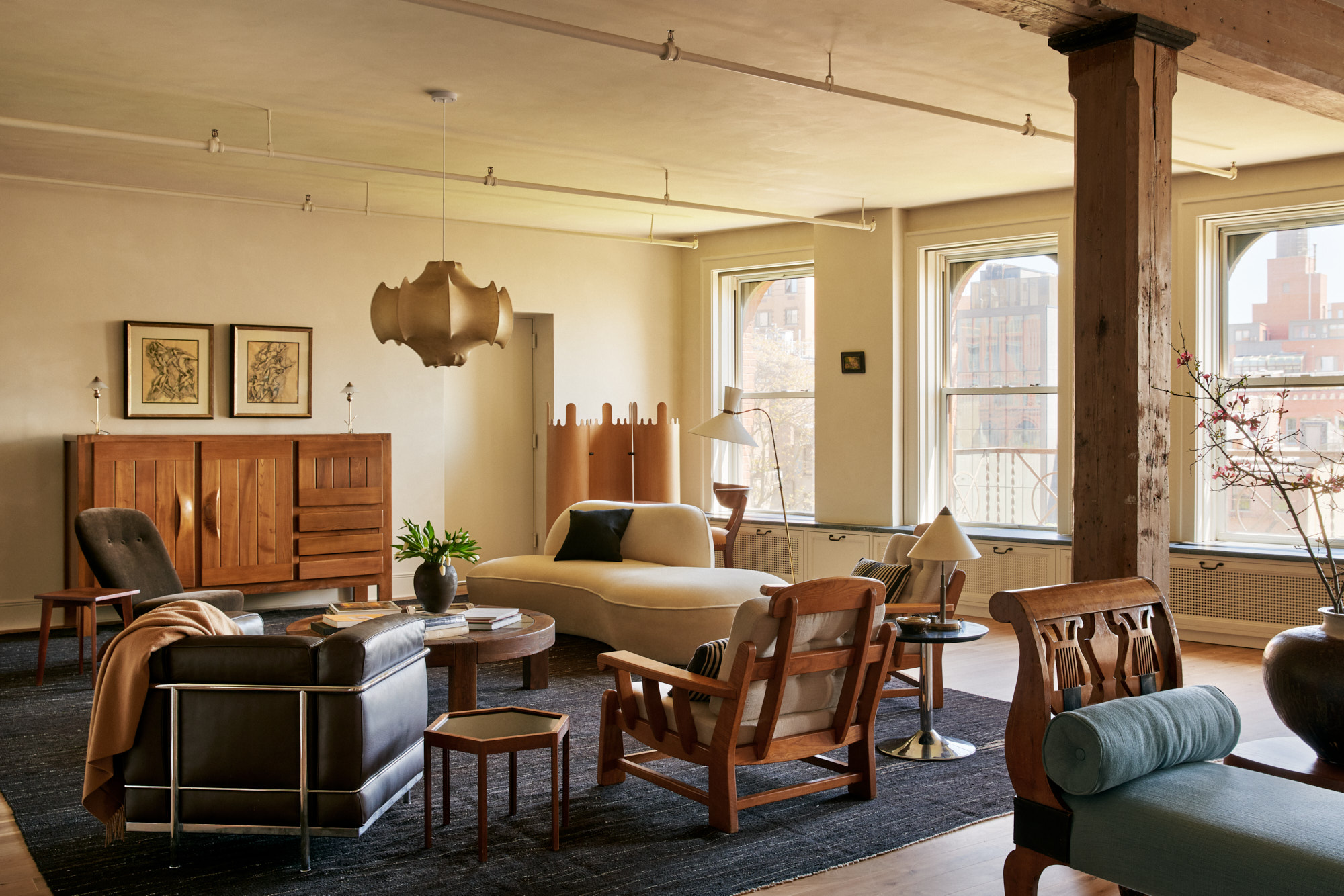 285 Lafayette Street, Unit 5D Manhattan, NY 10012 - Photo 2 of 22 a living room with furniture a flat screen tv and a floor to ceiling window
