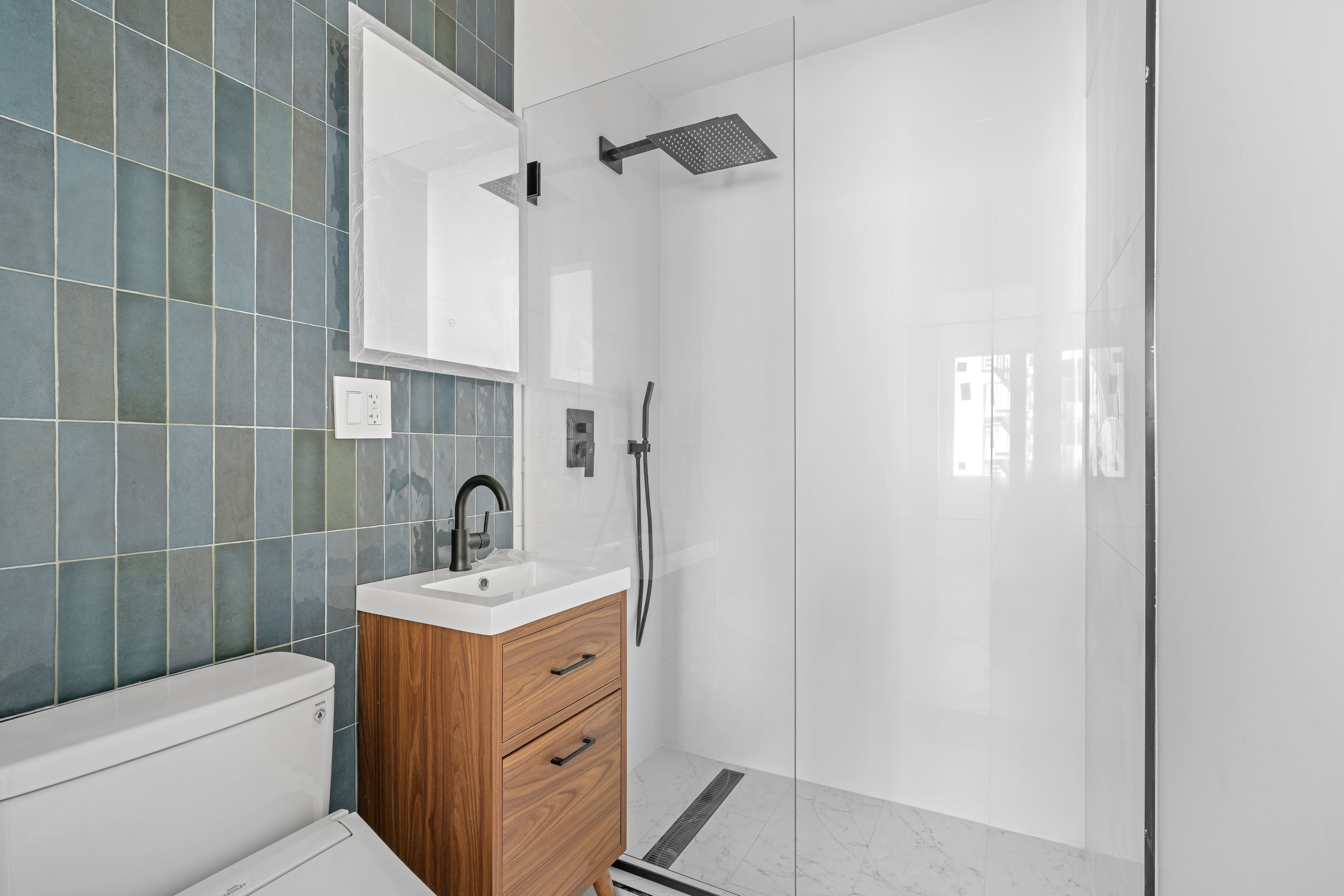 953 St Nicholas Avenue, Unit 1 Manhattan, NY 10032 - Photo 12 of 15 a bathroom with a sink a toilet and shower