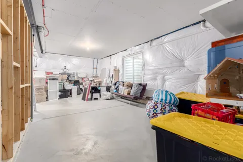 a living room with furniture and a mirror