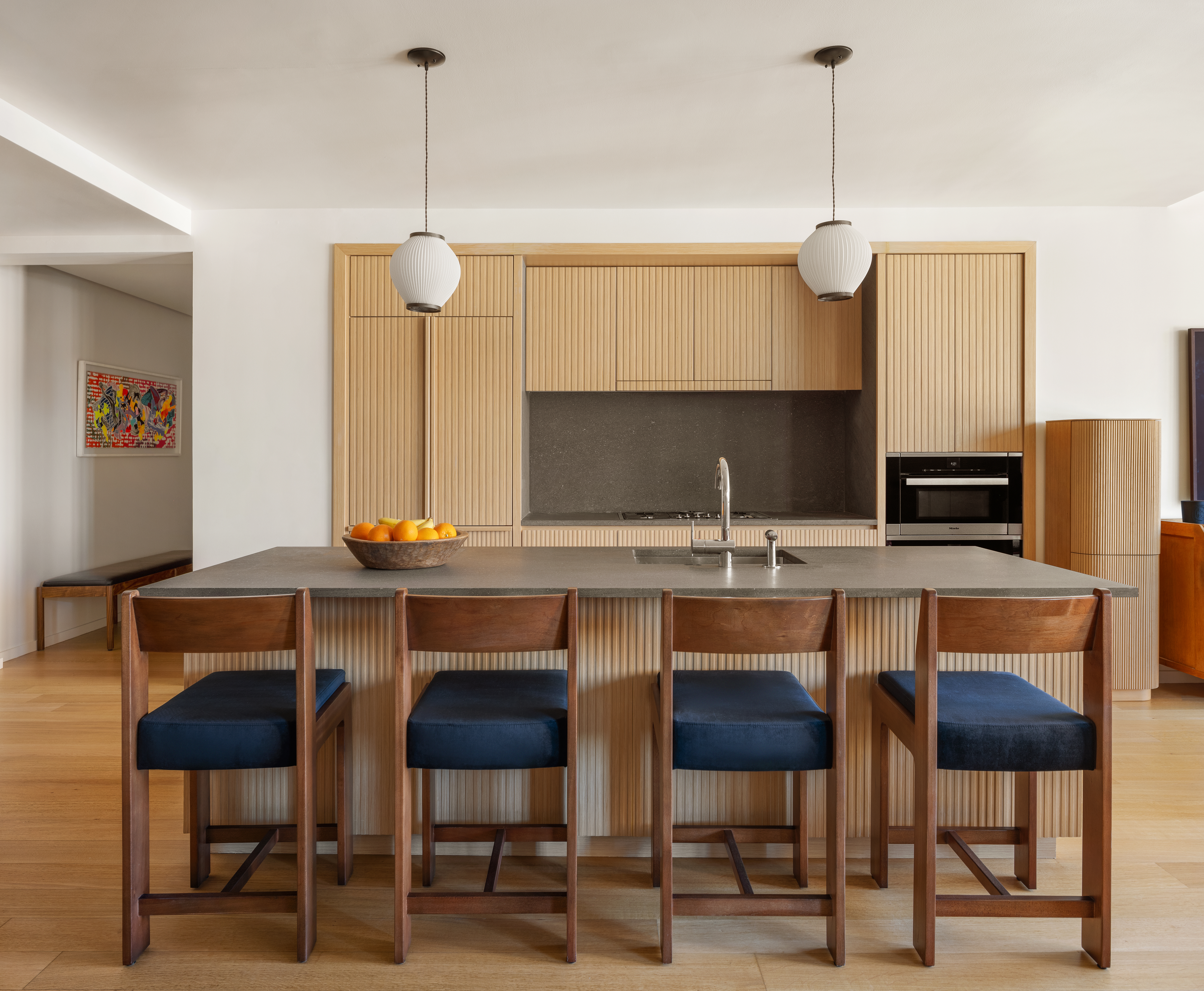 565 Broome Street, Unit N12E Manhattan, NY 10013 - Photo 2 of 19 a kitchen with a dining table chairs and white cabinets