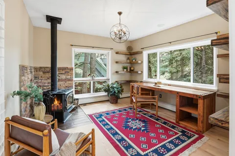 a living room with furniture a window and a chandelier