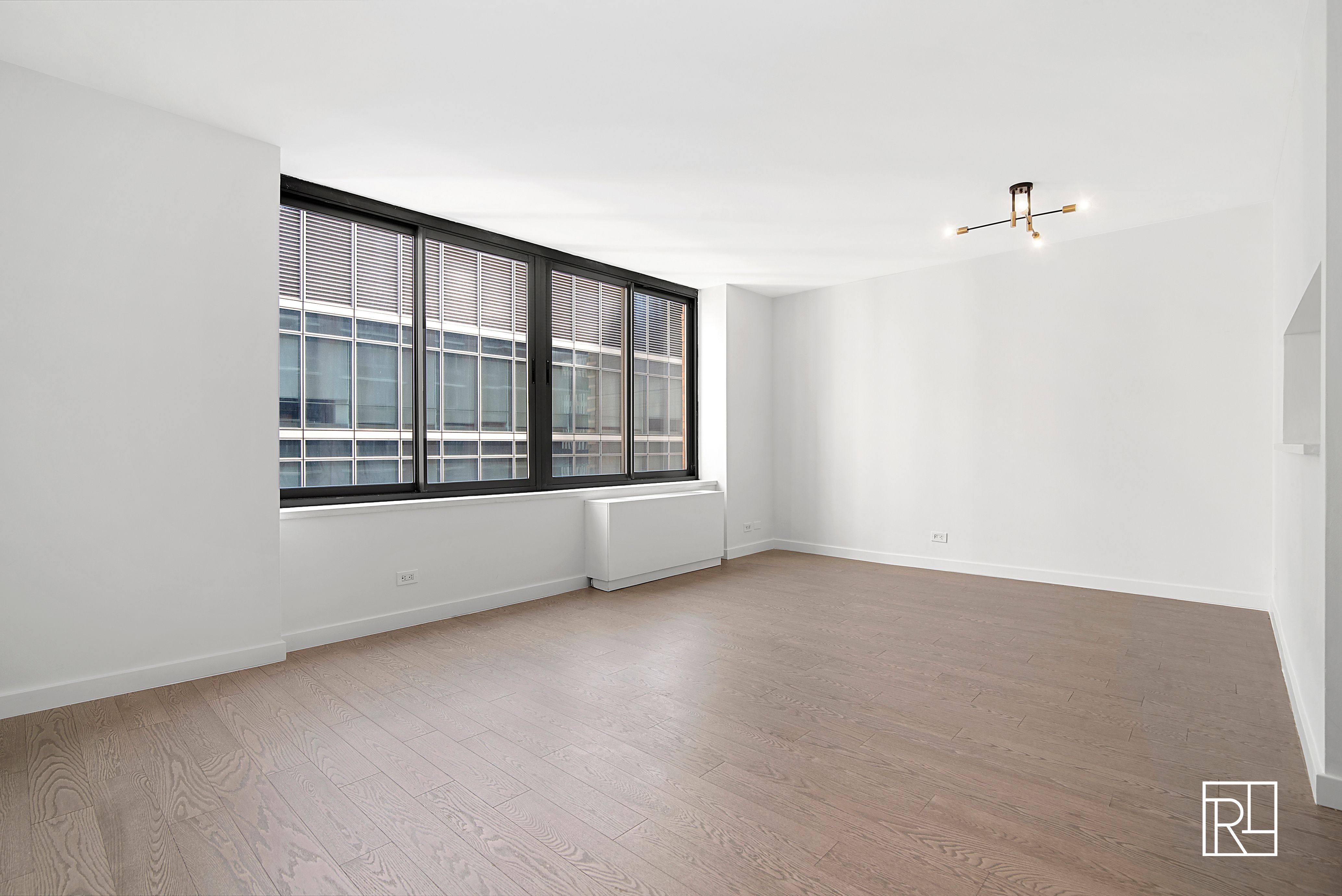 161 West 61st Street, Unit 12D Manhattan, NY 10023 - Photo 4 of 15 a view of an empty room with a window