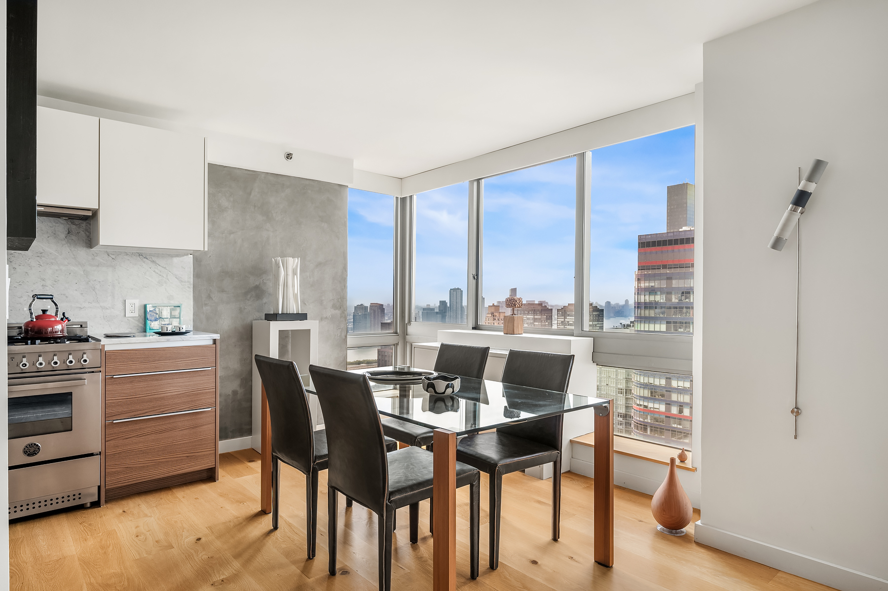 235 East 55th Street, Unit 44B Manhattan, NY 10022 - Photo 1 of 12 a dining room with furniture and a floor to ceiling window
