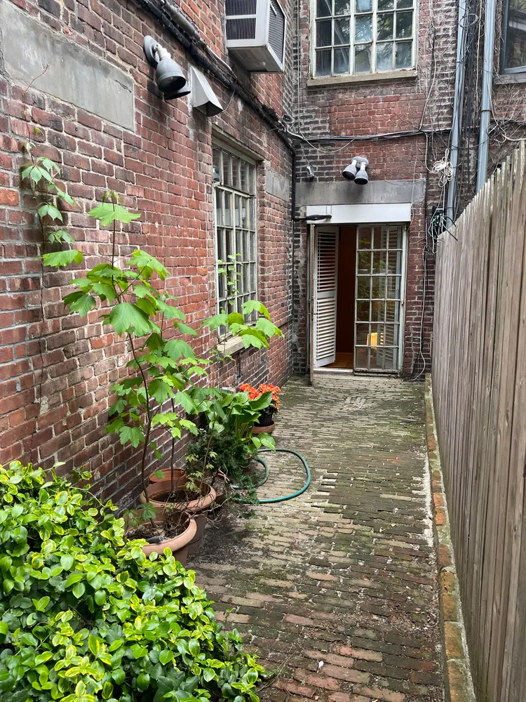 a view of a brick building with many windows
