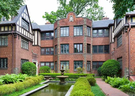 a aerial view of a brick house next to a yard