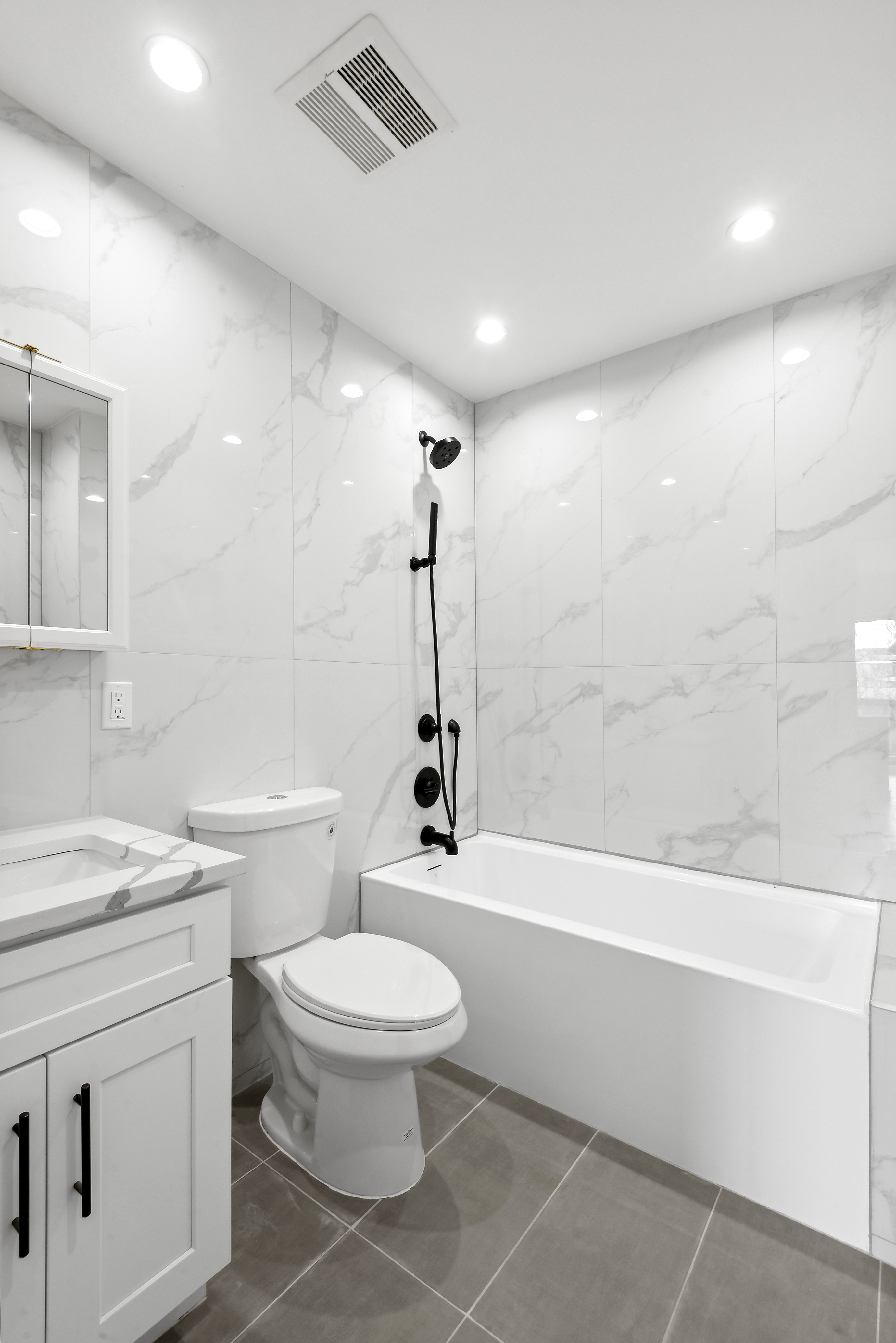 111 Woodbine Street, Unit 4 Brooklyn, NY 11221 - Photo 3 of 7 a bathroom with a toilet a sink a mirror and shower