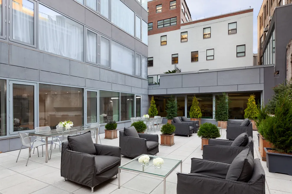 425 West 53rd Street, Unit 419 Manhattan, NY 10019 - Photo 13 of 18 a view of a patio with couches table and chairs and potted plants