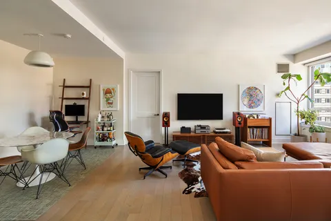 a living room with furniture a rug and a flat screen tv
