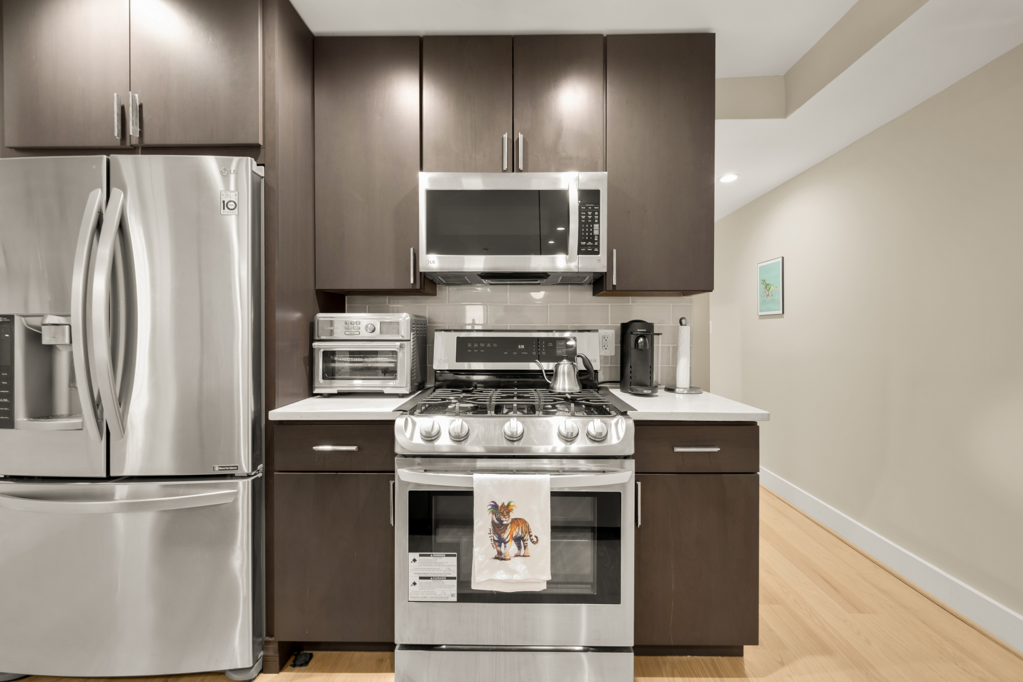 14 T Street Northeast, Unit 1 Washington, DC 20002 - Photo 22 of 39 a kitchen with stainless steel appliances a refrigerator a stove and a microwave