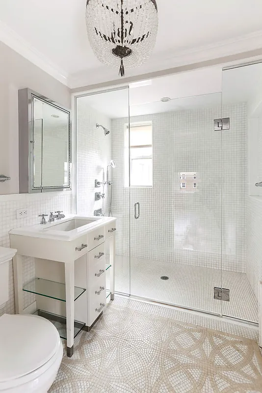 167 East 82nd Street, Unit 9B Manhattan, NY 10028 - Photo 8 of 15 a bathroom with a double vanity sink toilet and shower