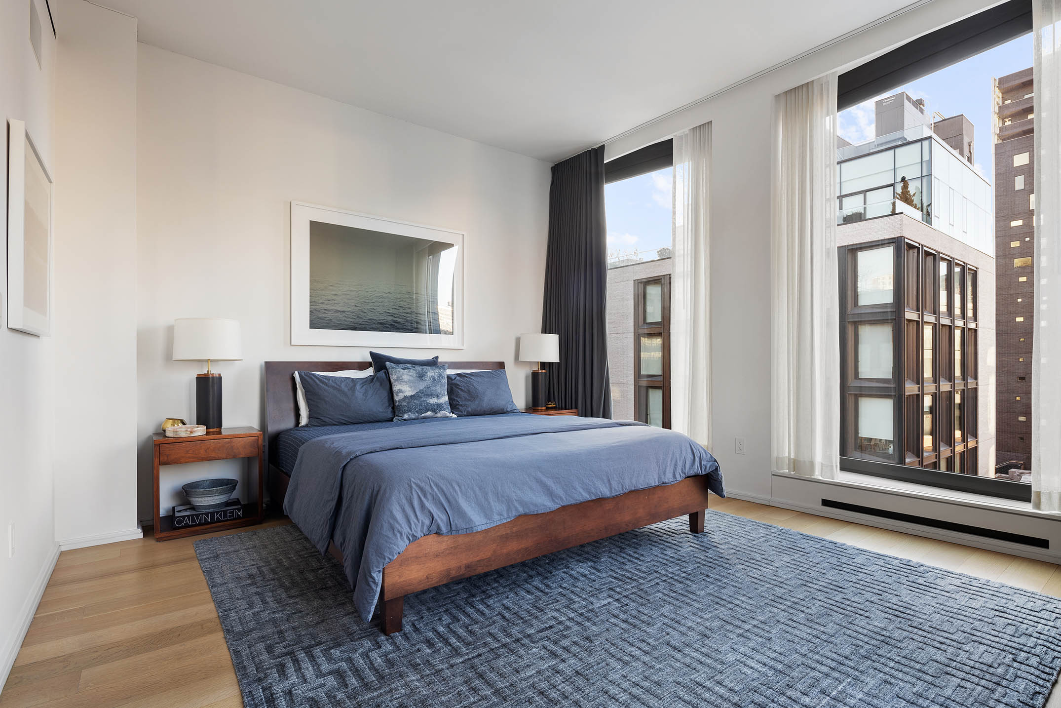 505 West 19th Street, Unit 8C Manhattan, NY 10011 - Photo 8 of 13 a bedroom with bed and large window