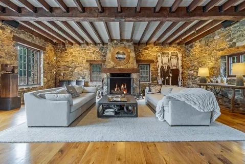 a living room with furniture a flat screen tv and a fireplace