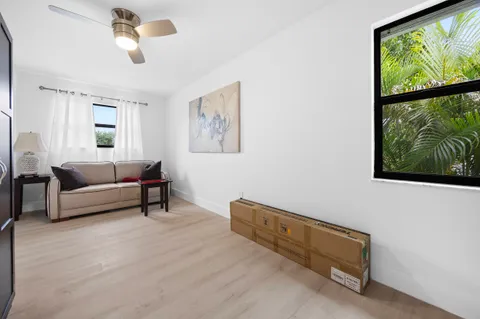a bedroom with a bed and a flat tv screen on the dresser