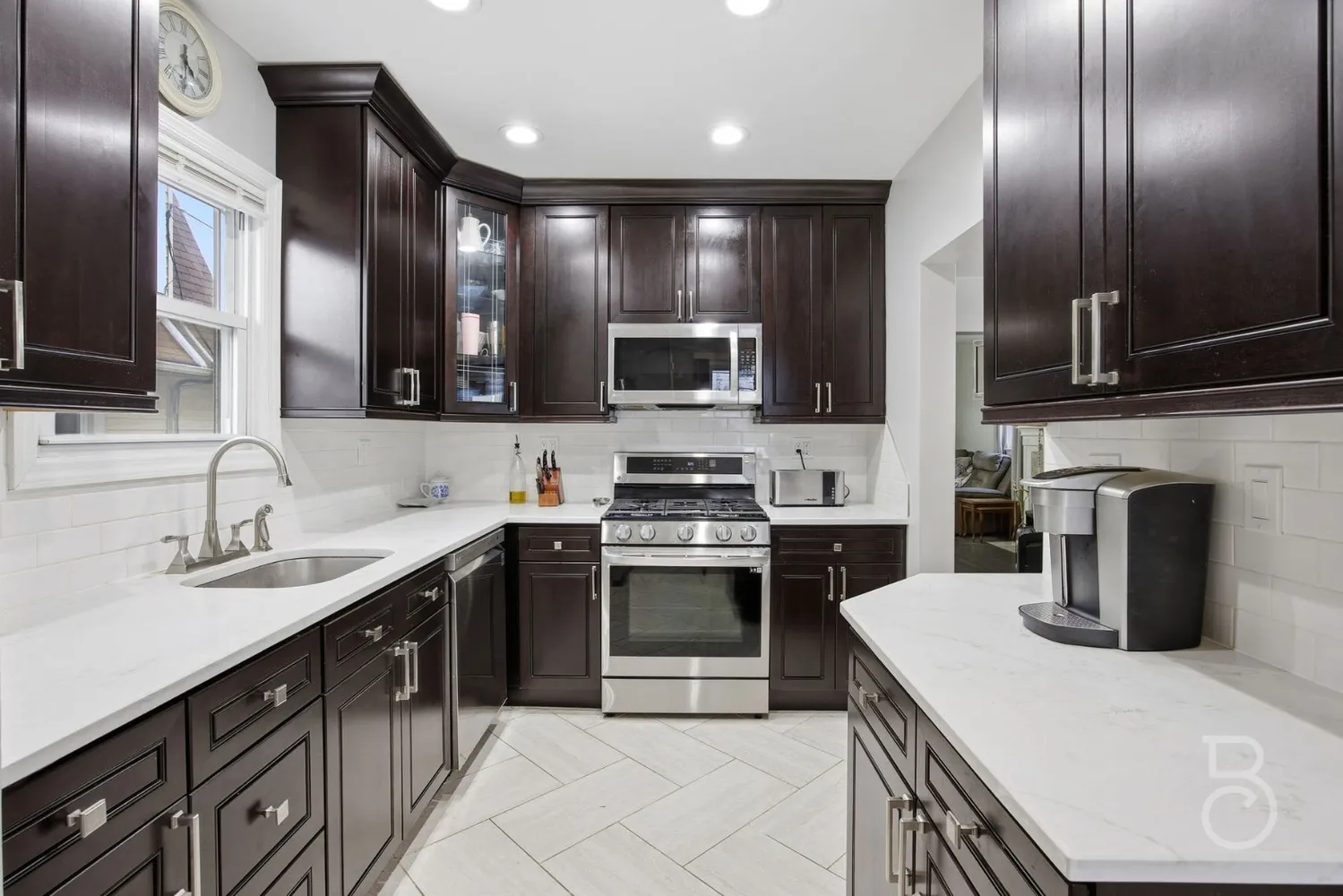 a kitchen with a sink stainless steel appliances and cabinets
