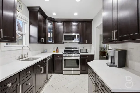 a kitchen with a sink stainless steel appliances and cabinets