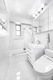 a bathroom with a sink a toilet and bathtub