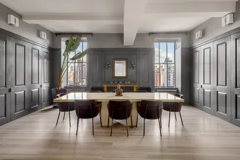 a view of a a dining room with furniture window and wooden floor
