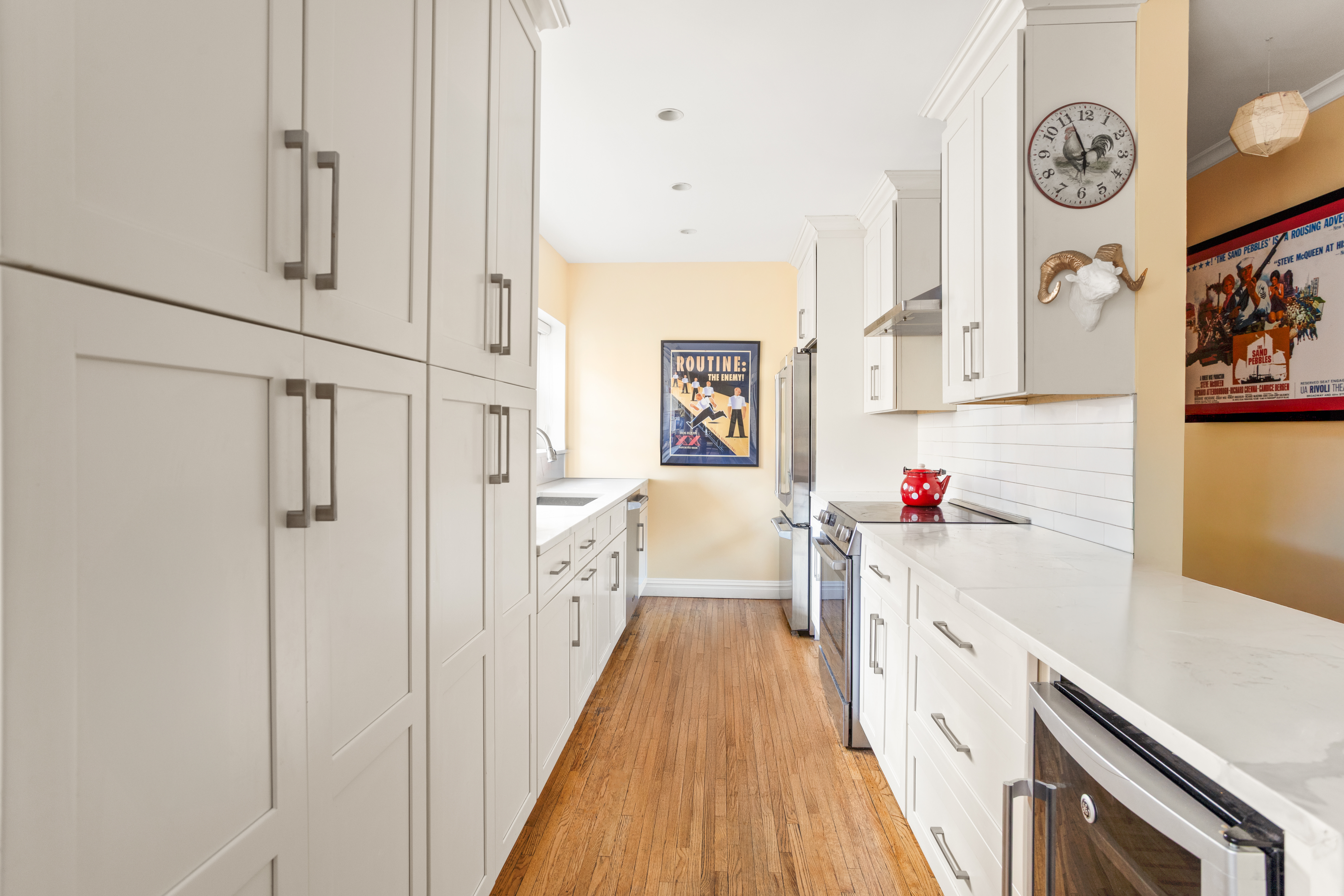 161 East 90th Street, Unit 5C Manhattan, NY 10128 - Photo 3 of 14 a kitchen with cabinets and wooden floor