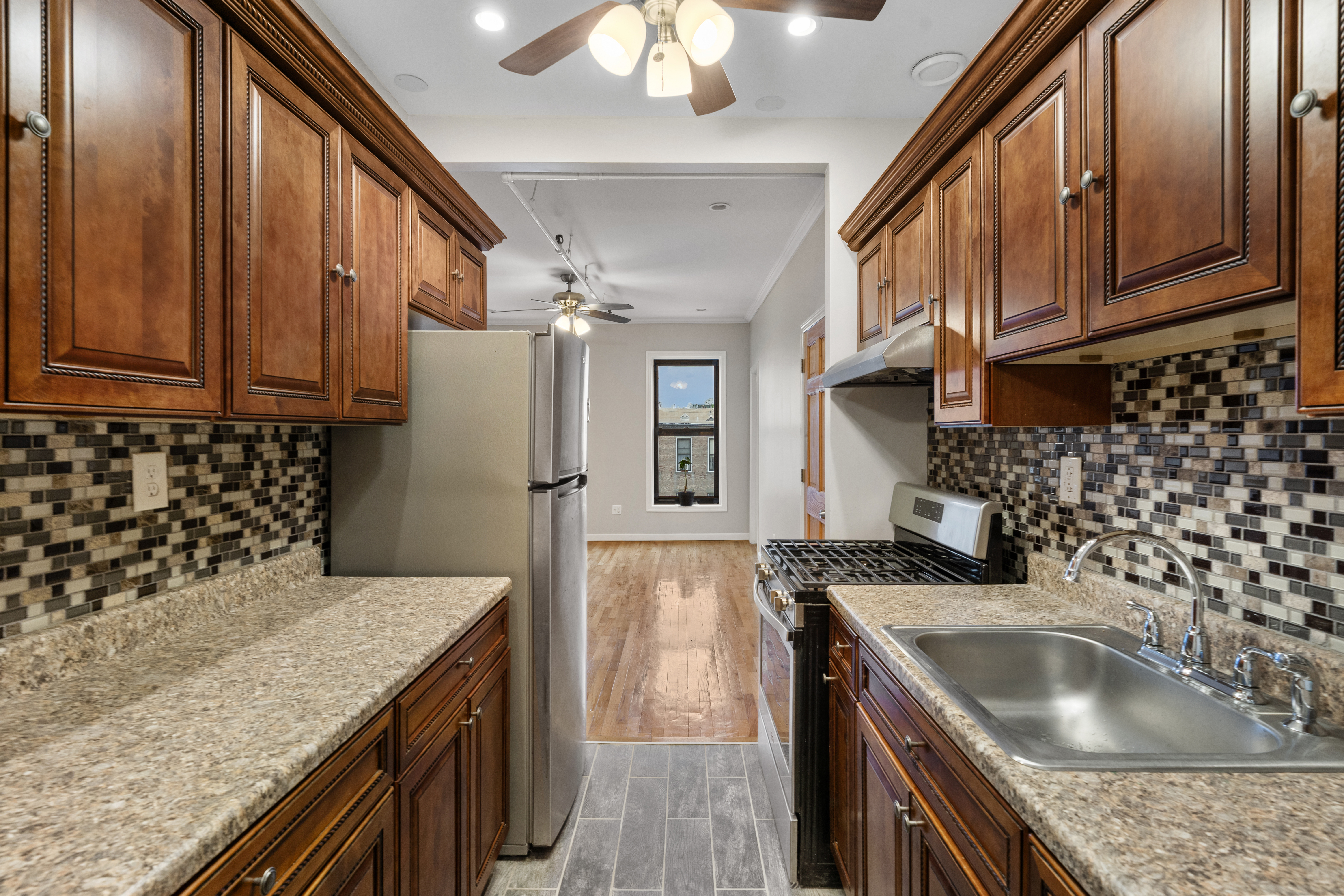 615 Putnam Avenue, Unit 4 Brooklyn, NY 11221 - Photo 4 of 10 a kitchen with a sink stove and microwave