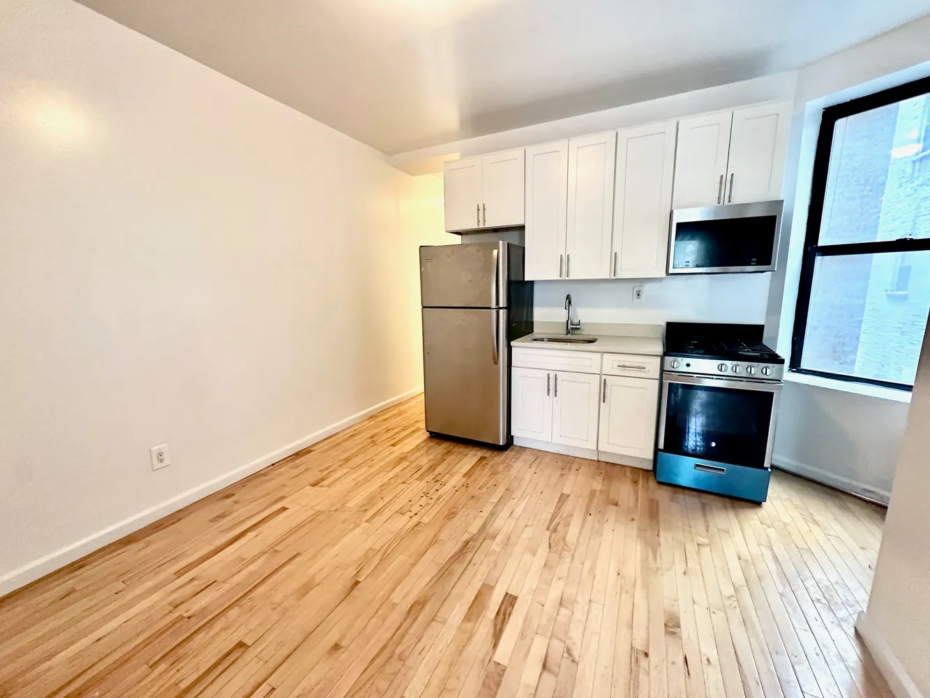 a kitchen with granite countertop a refrigerator and a stove