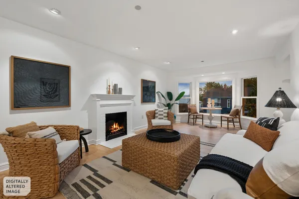 a living room with furniture fireplace and window