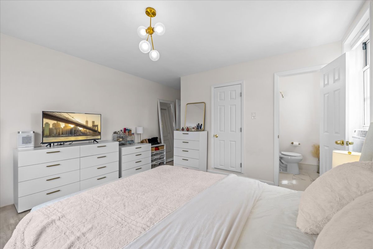 759 East 10th Street, Unit 7H Brooklyn, NY 11230 - Photo 8 of 15 a bedroom with a bed and furniture