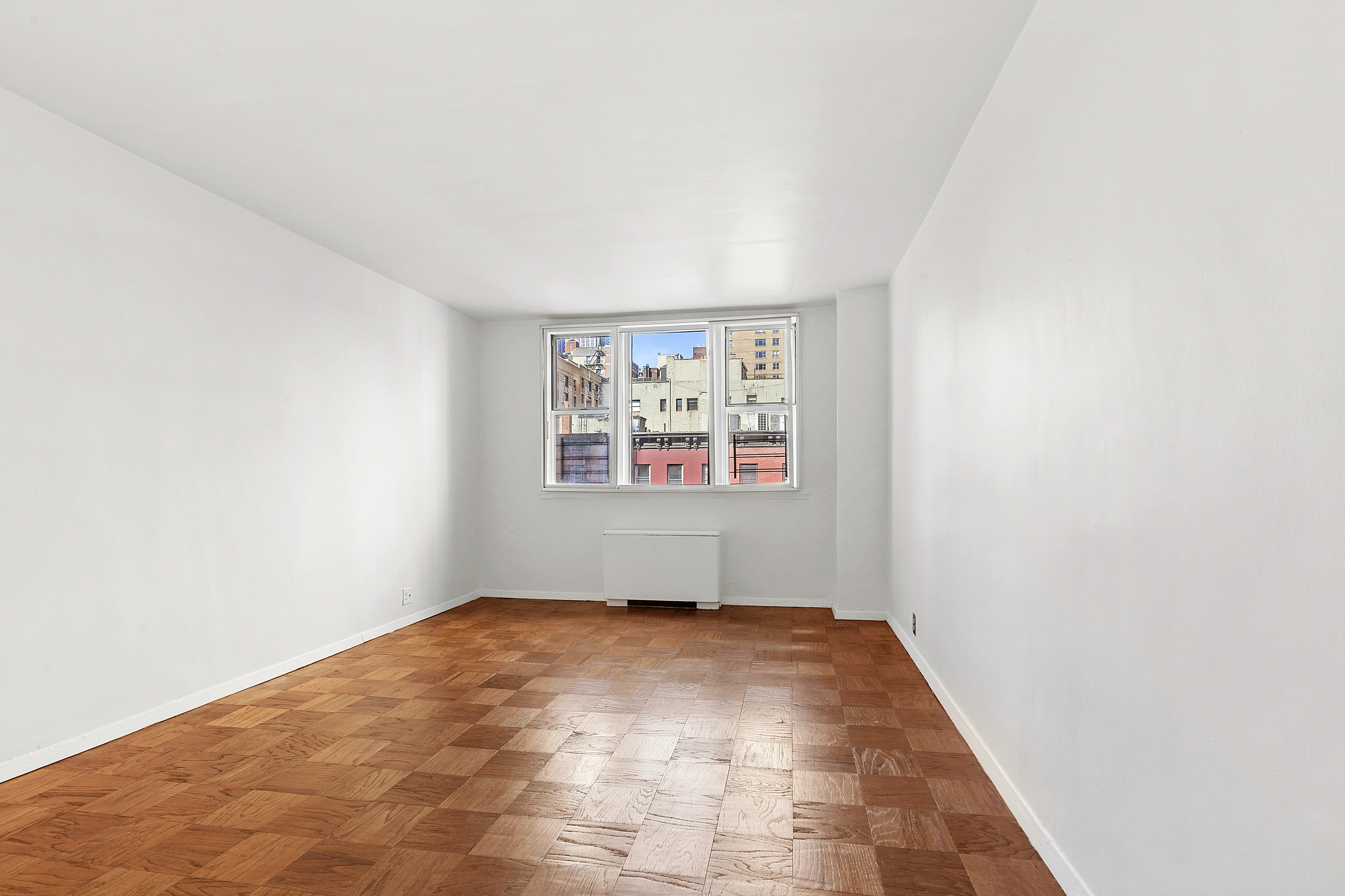 201 East 36th Street, Unit 5D Manhattan, NY 10016 - Photo 3 of 9 an empty room with windows