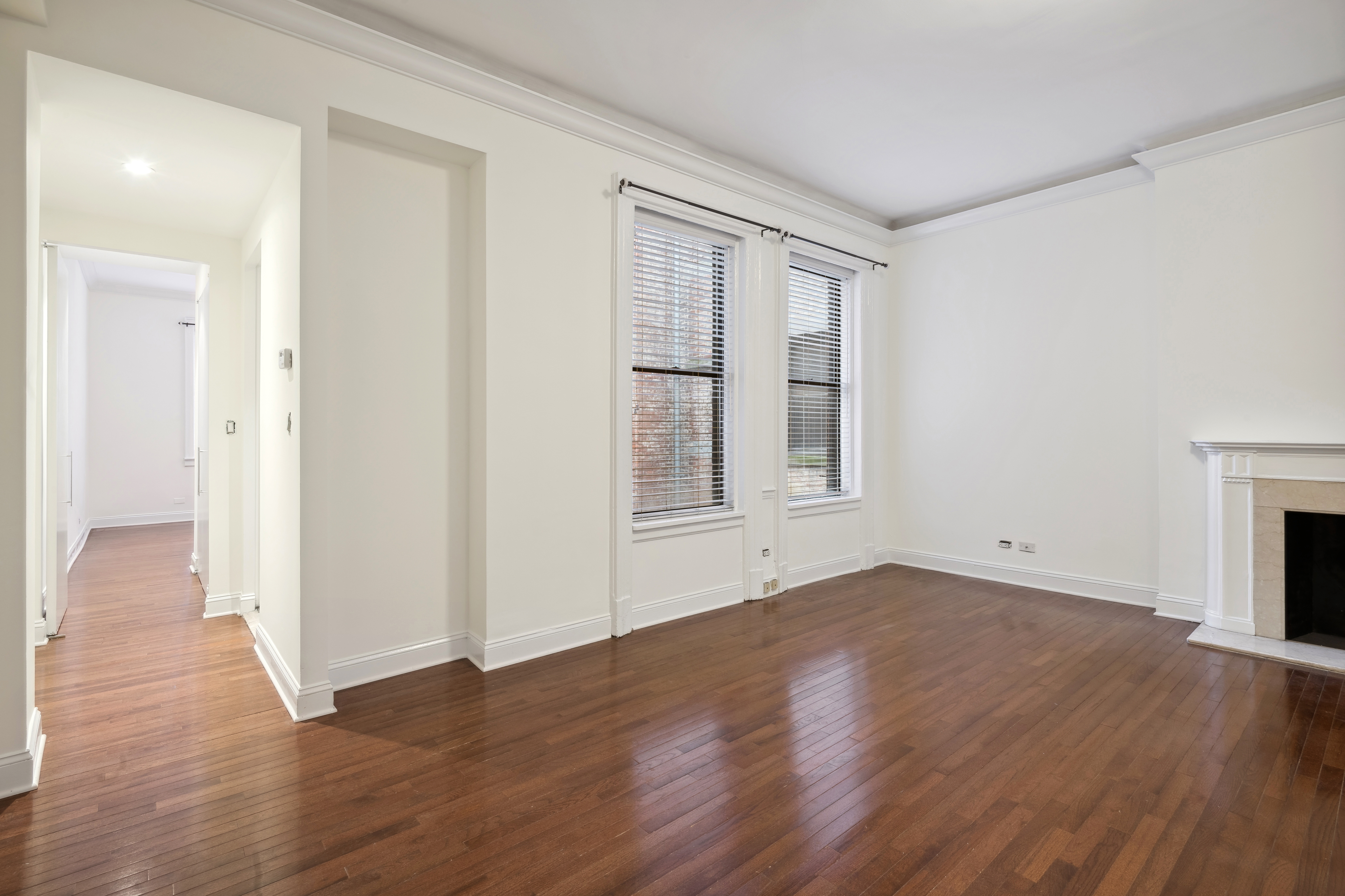 49 East 74th Street Manhattan, NY 10021 - Photo 7 of 11 a view of an empty room with wooden floor and a window