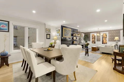 a kitchen with stainless steel appliances white cabinets and a stove top oven