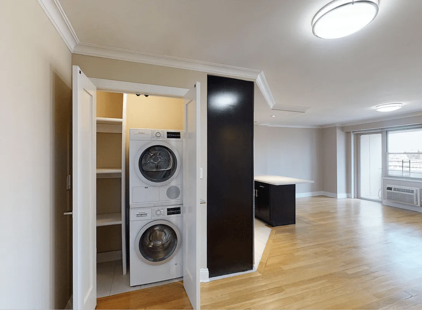 40 Harrison Street, Unit 24H Manhattan, NY 10013 - Photo 12 of 17 a view of washer and dryer in a utility room