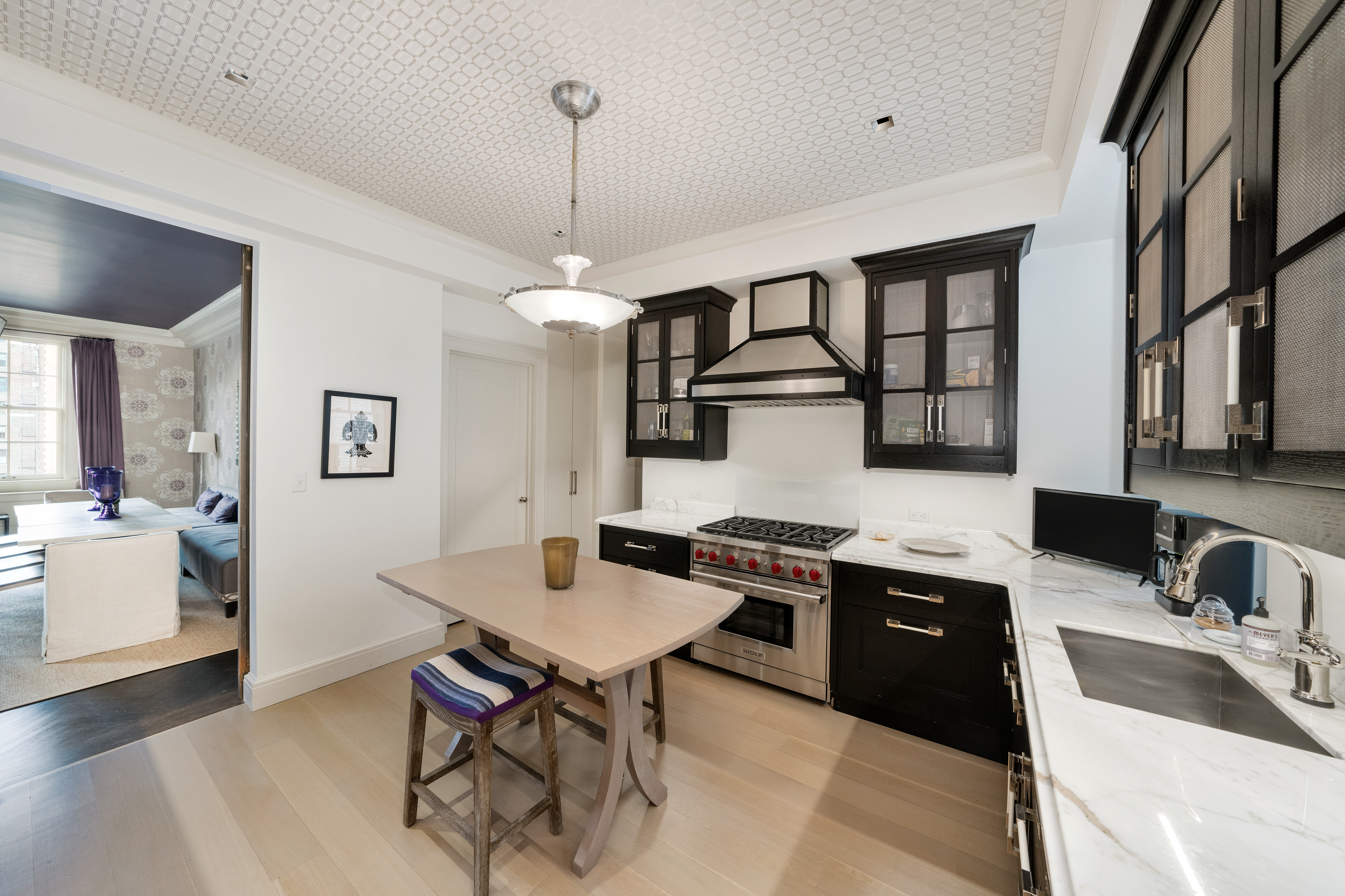 850 Park Avenue, Unit 9C Manhattan, NY 10075 - Photo 6 of 14 a kitchen that has a sink a stove and chairs