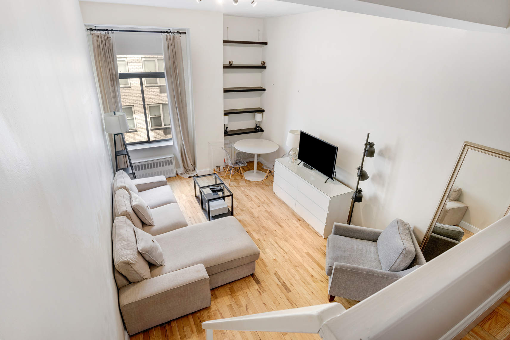 310 East 23rd Street, Unit 7C Manhattan, NY 10010 - Photo 3 of 18 a living room with furniture and a flat screen tv