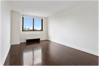 280 Park Avenue South, Unit 24E Manhattan, NY 10010 - Photo 5 of 6 a view of an empty room with wooden floor and a window