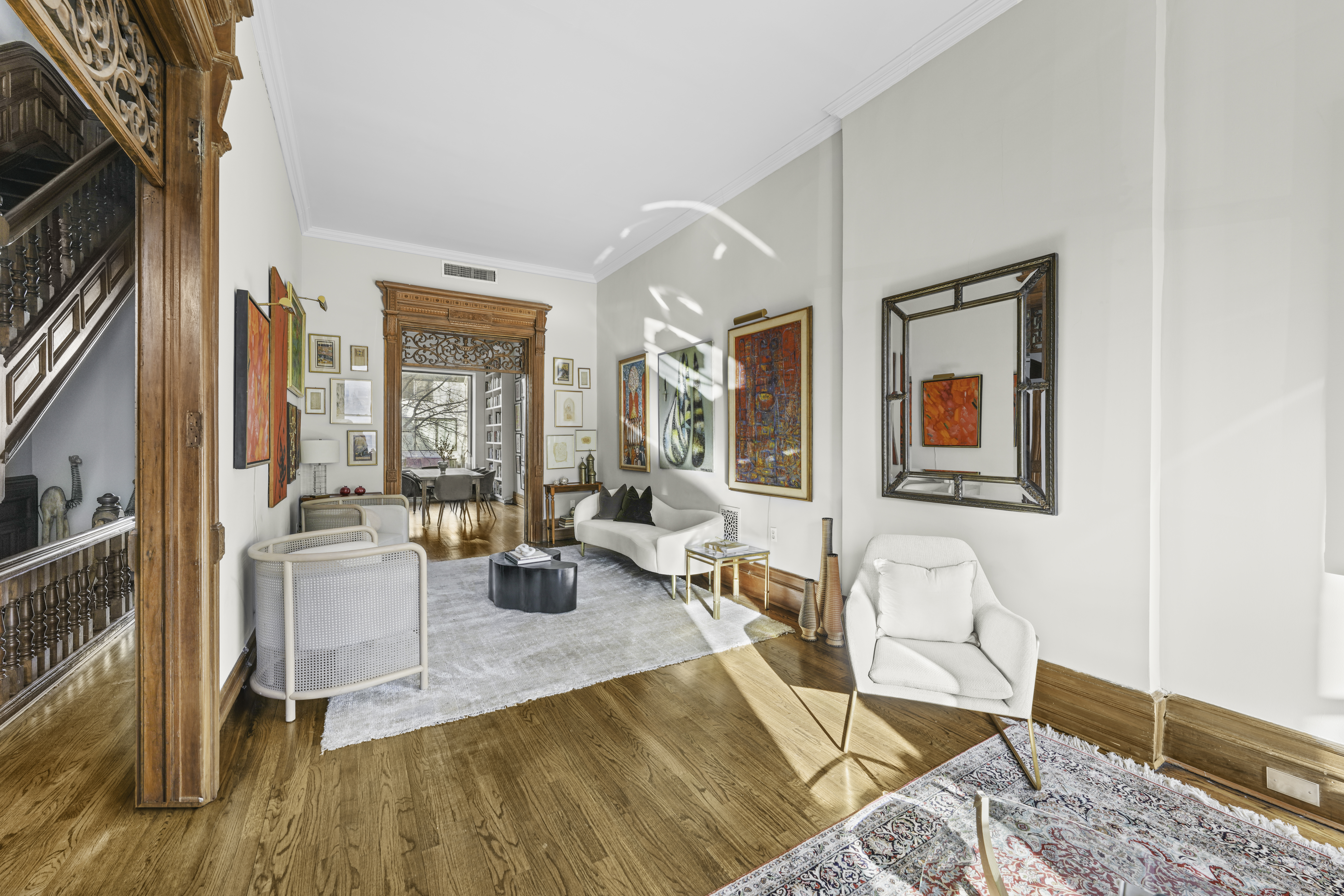 127 West 122nd Street Manhattan, NY 10027 - Photo 5 of 17 a living room with furniture and a floor to ceiling window