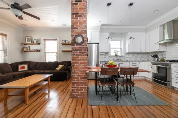 a living room with lots of furniture and kitchen view