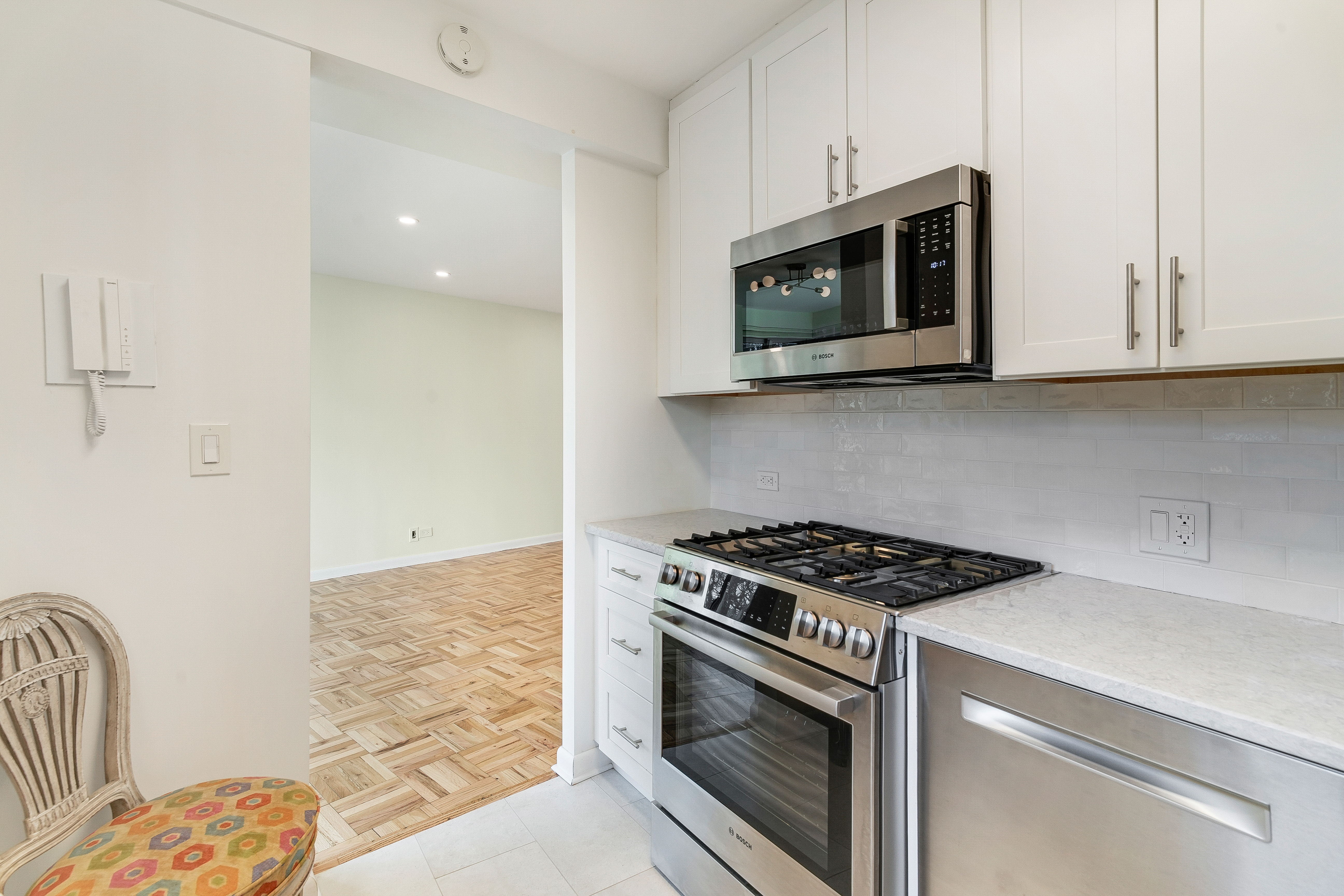 4455 Douglas Avenue, Unit 8A Bronx, NY 10471 - Photo 6 of 22 a kitchen with stainless steel appliances granite countertop white cabinets and a stove