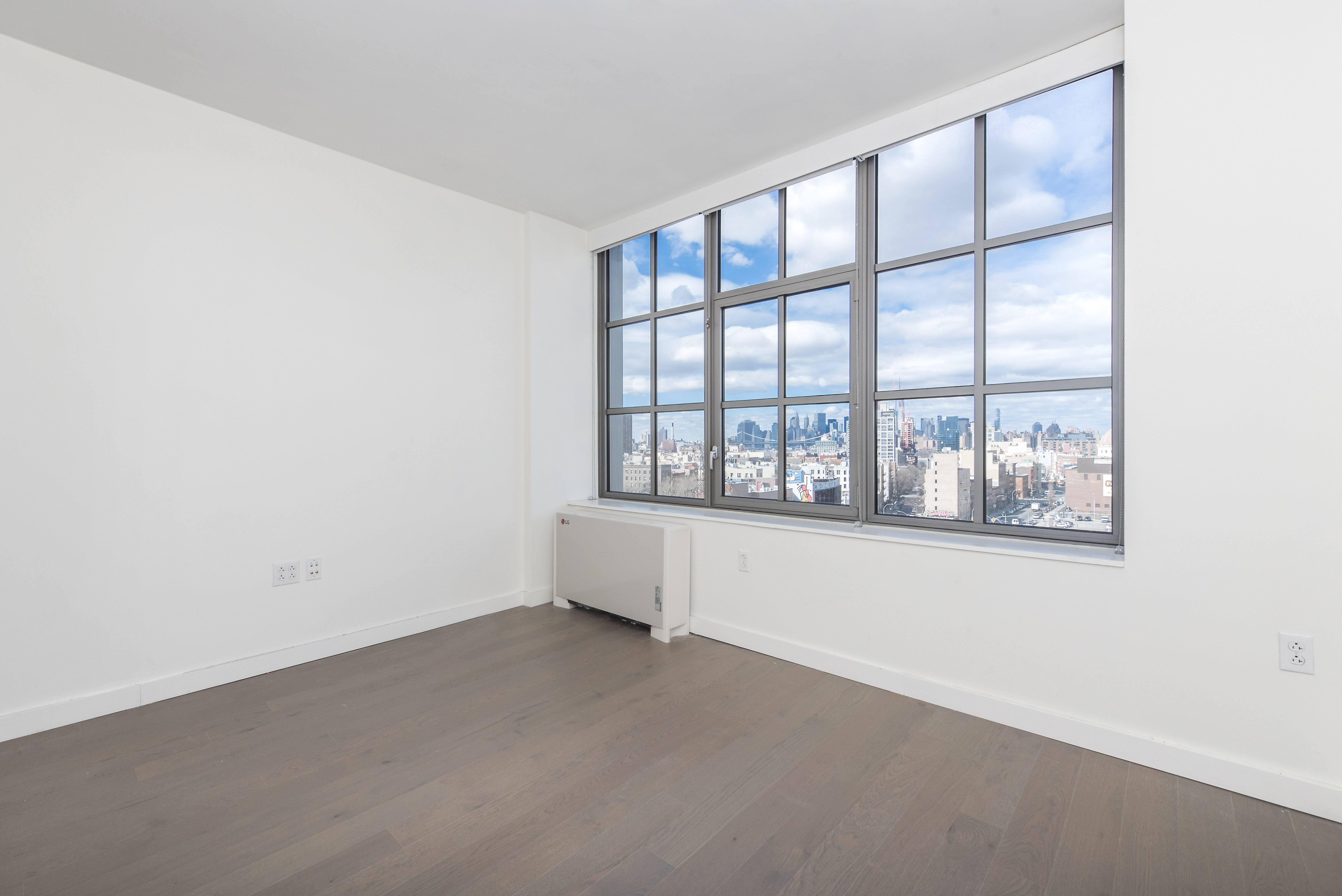 282 South 5th Street, Unit 7F Brooklyn, NY 11211 - Photo 4 of 16 an empty room with windows