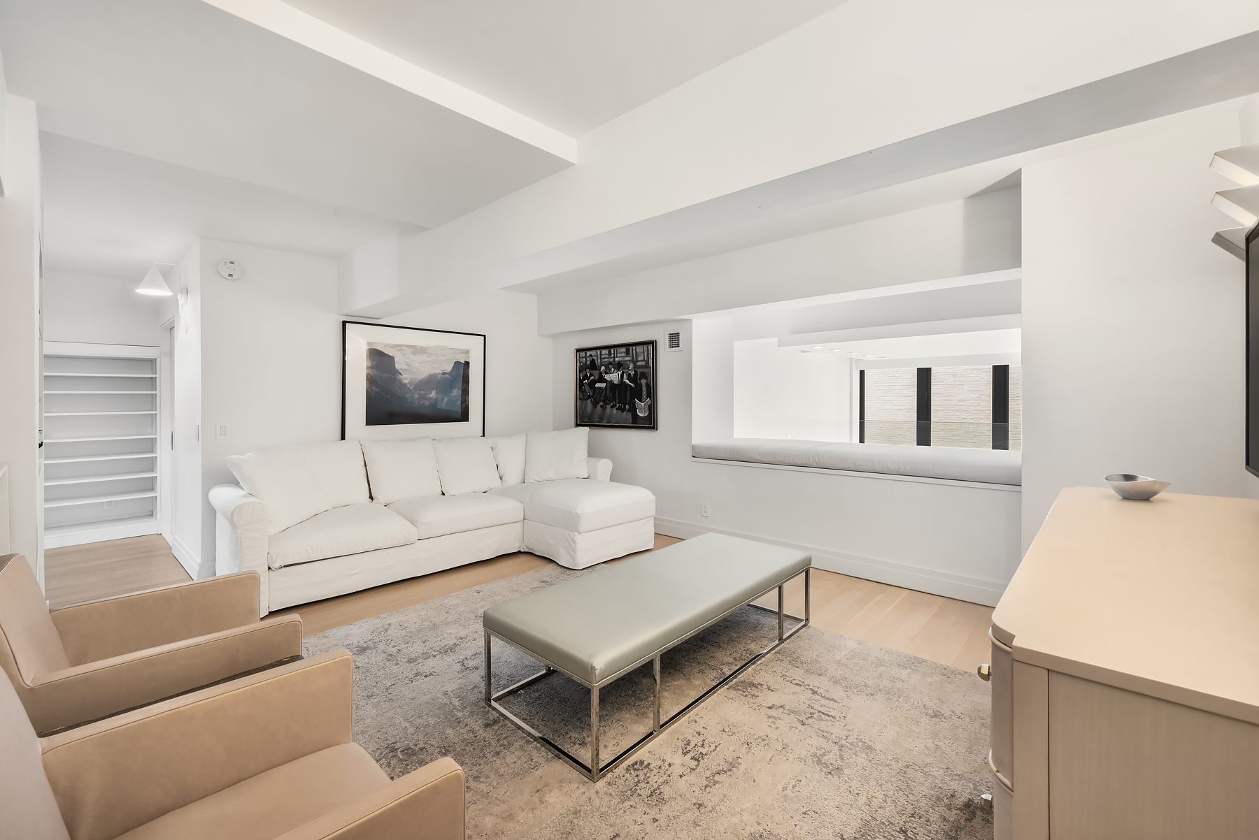 421 Hudson Street, Unit 320 Manhattan, NY 10014 - Photo 7 of 13 a living room with furniture and a flat screen tv