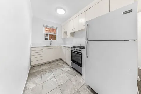 a kitchen with stainless steel appliances a refrigerator sink and cabinets