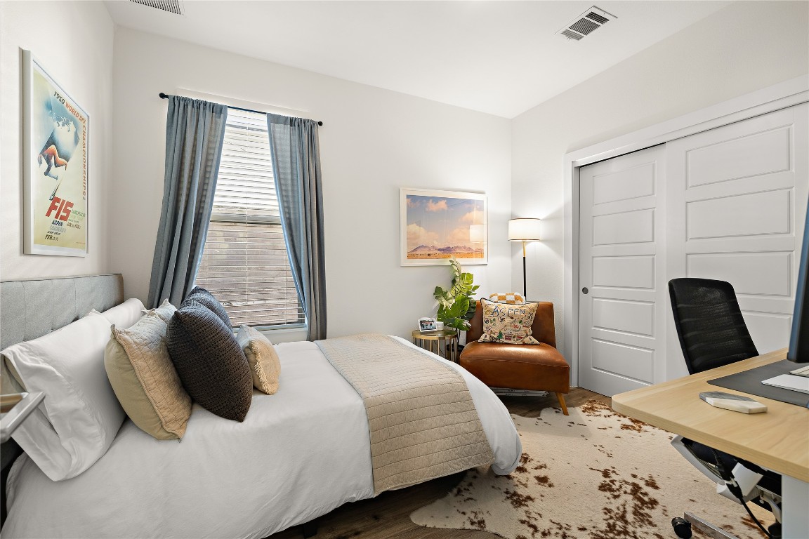1402 Singleton Avenue, Unit B Austin, TX 78702 - Photo 16 of 26 a bedroom with a bed window and a table
