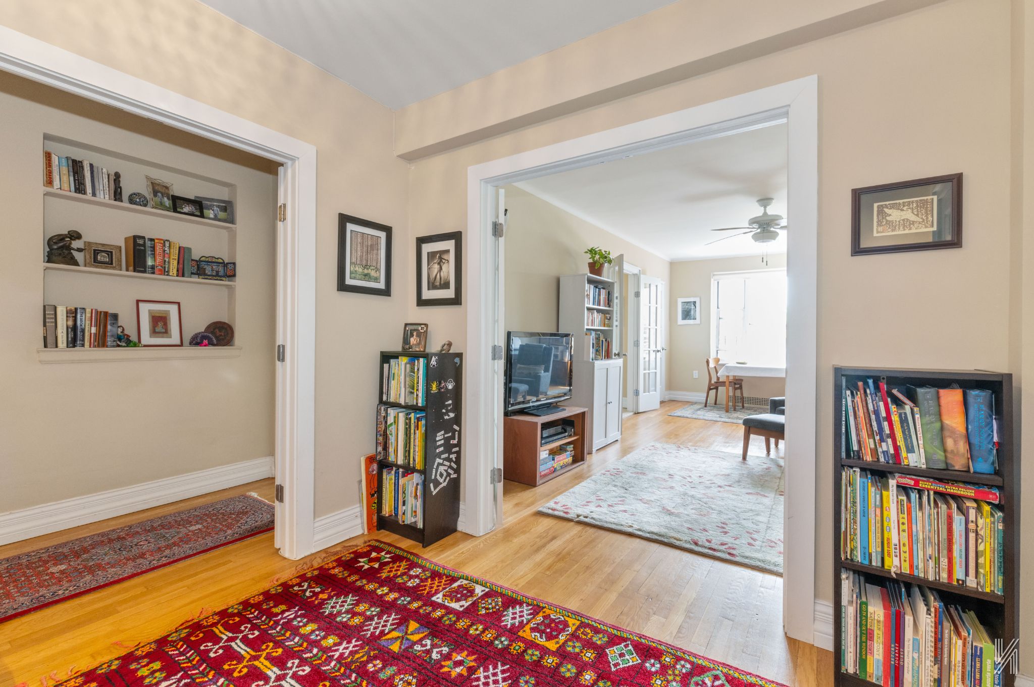 34-41 85th Street, Unit 4P Queens, NY 11372 - Photo 6 of 20 a living room with lots of furniture and a book shelf