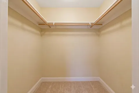 a spacious bedroom with a bed and a couch