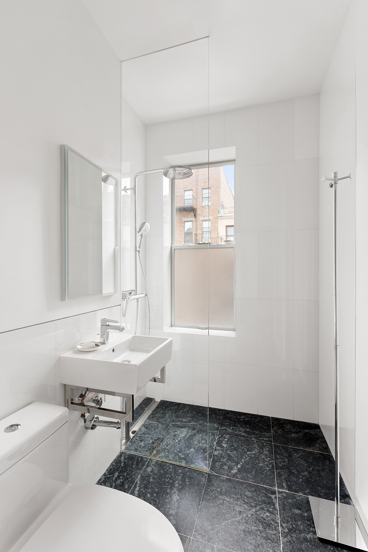 525 East 84th Street, Unit 3B Manhattan, NY 10028 - Photo 8 of 10 a bathroom with a sink toilet and vanity
