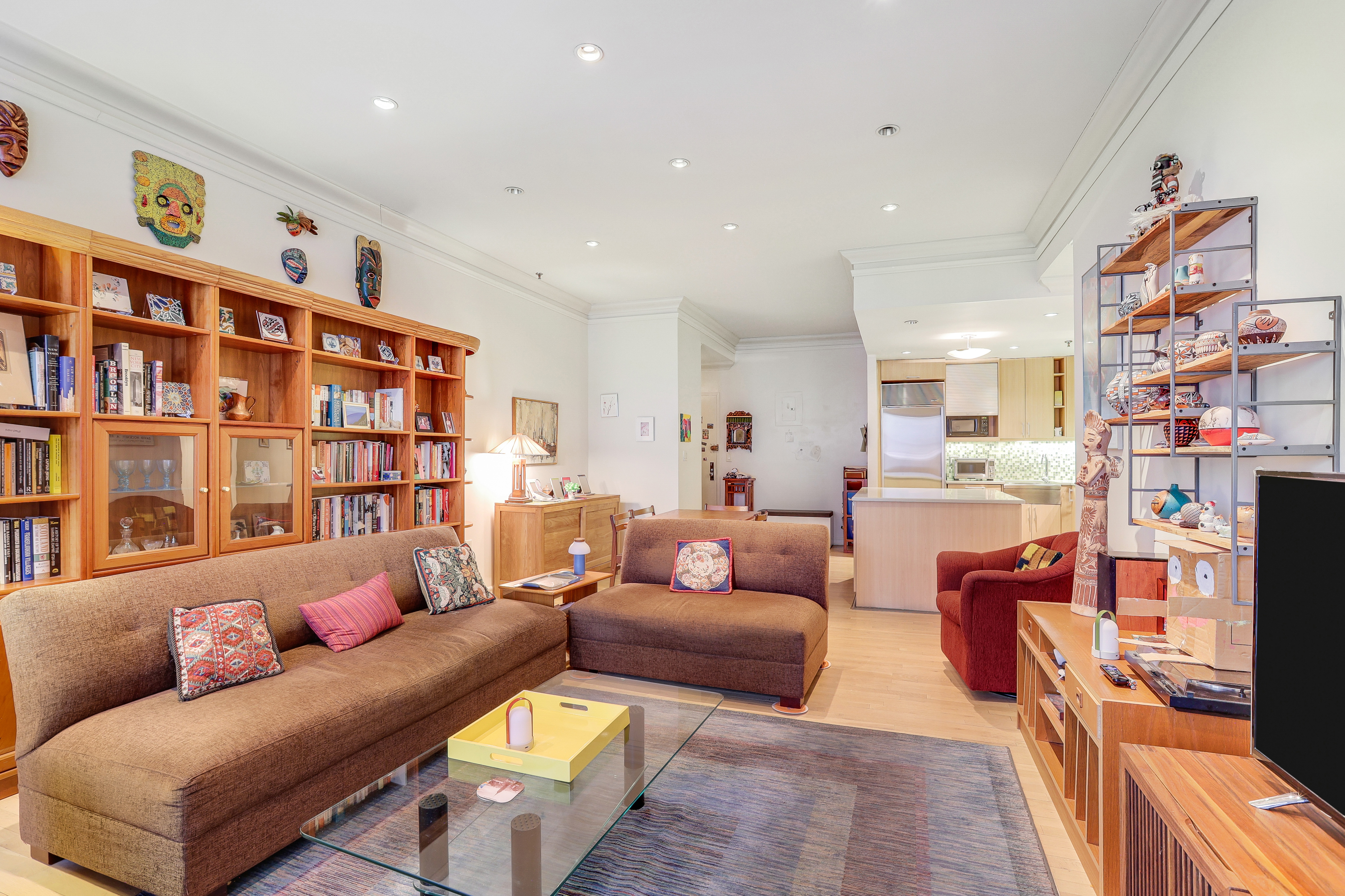 136-140 West 23rd Street, Unit 4C Manhattan, NY 10011 - Photo 3 of 12 a living room with furniture a bookshelf and a book shelf