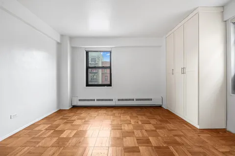 a view of a room with wooden floor and white walls