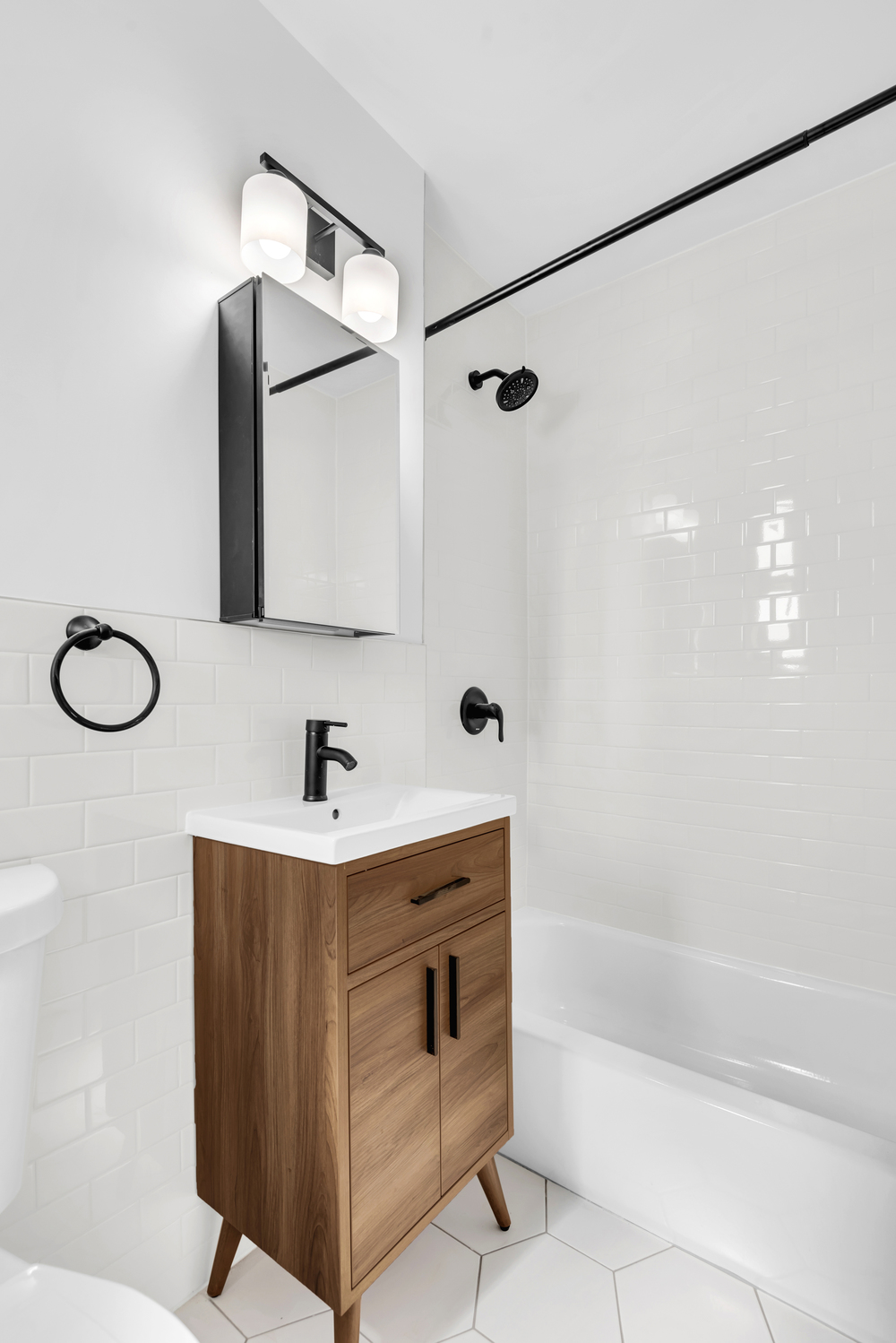 48-21 40th Street, Unit 5H Queens, NY 11104 - Photo 5 of 5 a bathroom with a bathtub and a shower