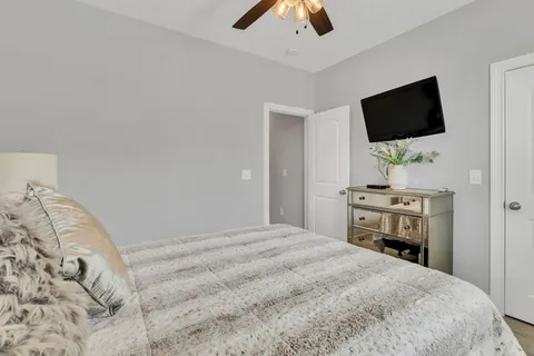 a bedroom with a bed and a flat screen tv