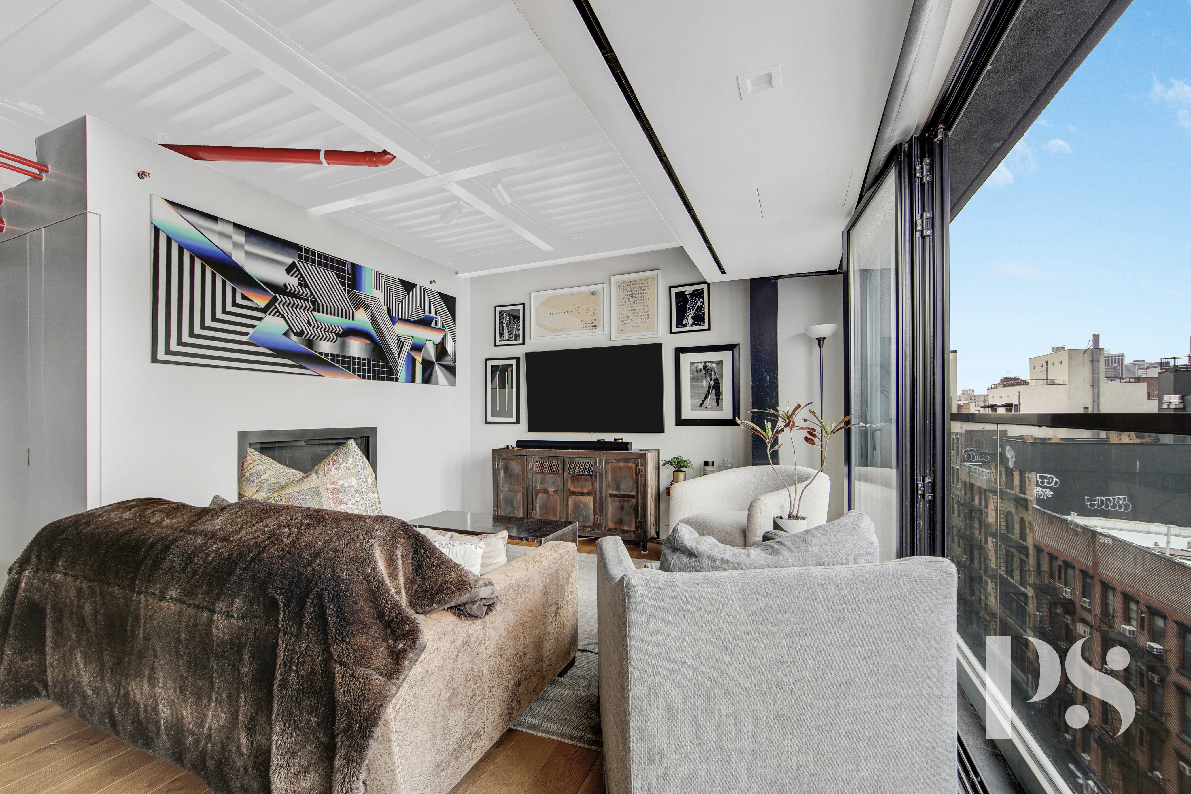 60 Orchard Street, Unit PH Manhattan, NY 10002 - Photo 4 of 19 a bedroom with furniture and a flat screen tv