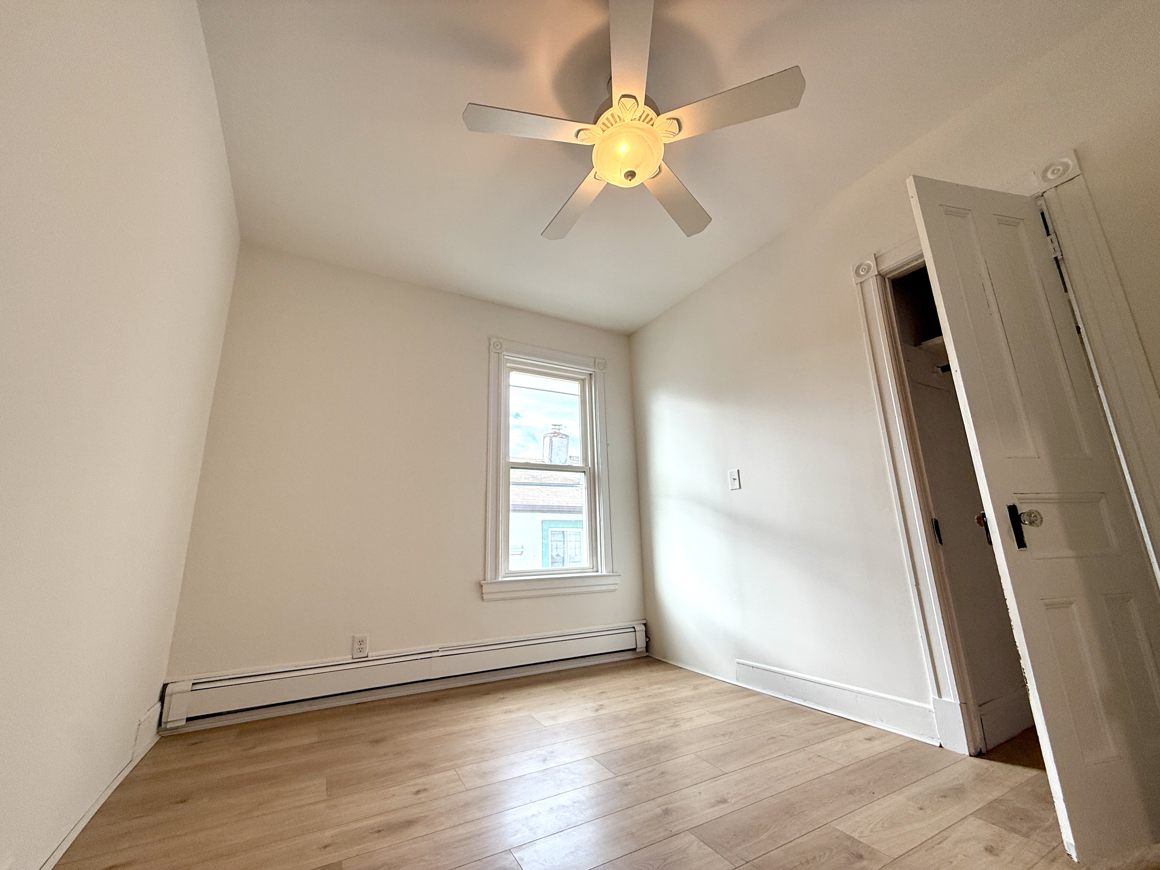 31 Seeley Street, Unit Undisclosed Brooklyn, NY 11218 - Photo 15 of 31 an empty room with wooden floor and windows